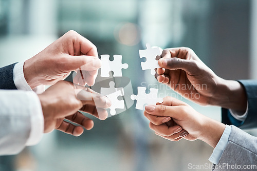 Image of Puzzle, hands and group of people for solution, teamwork and goals, achievement and workflow success. Team building, games and development of woman and staff problem solving, synergy or collaboration