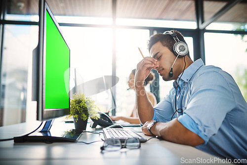 Image of Businessman, call center and headache with green screen in burnout, stress or overworked at office. Man person, consultant or agent with bad head pain or anxiety with mockup chromakey at workplace