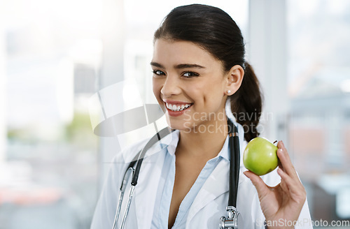 Image of Doctor, portrait and happy woman with apple for nutrition, healthy diet or wellness. Face, nutritionist or medical professional with fruit for advice, healthcare or natural food for vegan benefits