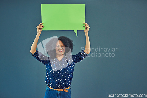 Image of Mockup, poster and woman portrait with speech bubble in studio for news or social media blue background. Space, voice and female person advertising opinion with paper, sticker and branding promotion