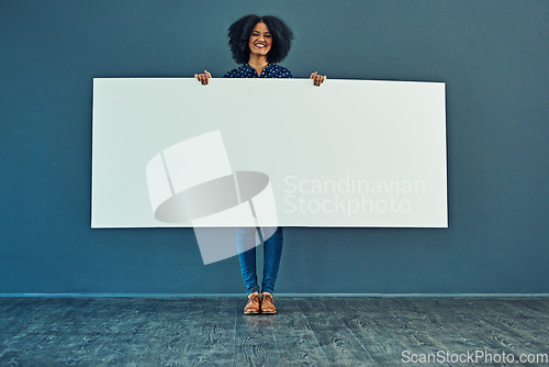 Image of Banner, mockup and portrait of happy woman in studio with billboard for news, social media or advertising on blue background. Space, paper and girl smile with poster, sign and branding promotion