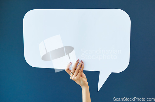 Image of Hand, speech bubble and woman in studio with banner, news or announcement on blue background. Mockup, poster and girl fingers with billboard for social media, advertising or opinion, vote or space