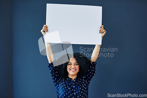 Image of Paper, mockup and portrait of happy woman in studio with banner for news, social media or advertising on blue background. Space, billboard and female smile with poster, sticker and branding promotion