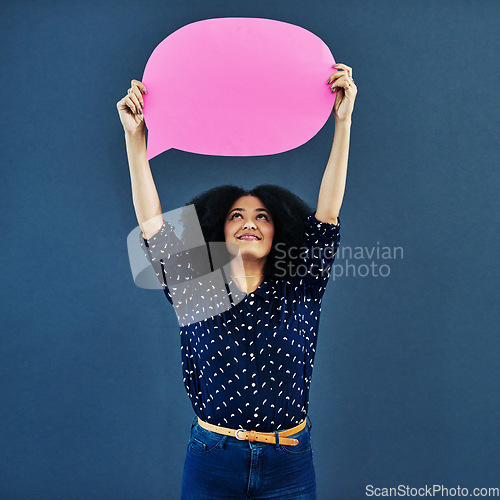 Image of Speech bubble, mockup and woman in studio with banner for news, social media or advertising on blue background. Space, billboard and female person with paper, poster or branding, launch or promotion