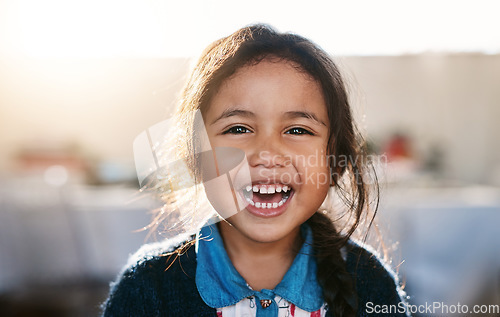 Image of Happy kid, face and girl laughing in living room, playing and having fun in her home. Child, development and portrait of Mexican female toddler with funny, joke or reaction to crazy comedy in a house