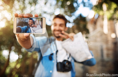 Image of Man, phone screen and travel selfie outdoor in a city with holiday memory, smile and peace sign. Male person outdoor for adventure, journey or vacation photo and freedom with hand for emoji or icon