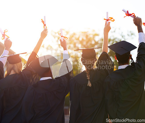 Image of Group, students and graduation diploma of college or university friends together from behind. Men and women outdoor to celebrate education achievement, success or certificate in hands at school event