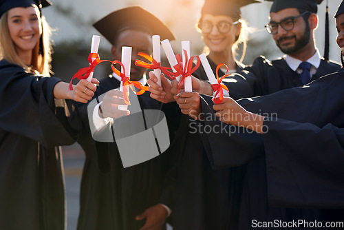 Image of Graduation, students and diploma in hands of college or university friends together. Diversity men and women group outdoor to celebrate education achievement, success and certificate at school event