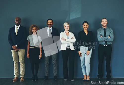 Image of Happy, smile and portrait of business people in studio for support, advisory and teamwork. Diversity, collaboration and professional lawyer with employees and wall background for legal mission