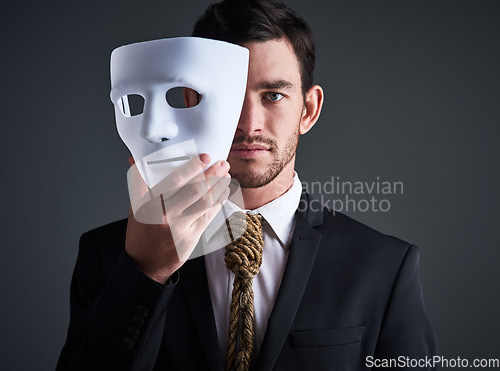 Image of Two faced portrait, mask and fake businessman in a studio with serious face with secret personality. Manager and corporate male with rope tie showing corporate slavery and control in business suit