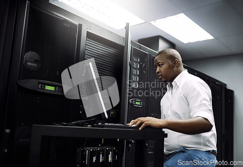 Image of IT support, black man or coding on laptop in server room for big data, network glitch or digital website. Code, fixing or technician typing on computer testing UX, programming or software development