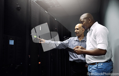 Image of Server room, people or technicians with tablet for hardware, cybersecurity glitch or error with teamwork. Black man, collaboration or engineers fixing network for information technology or IT support