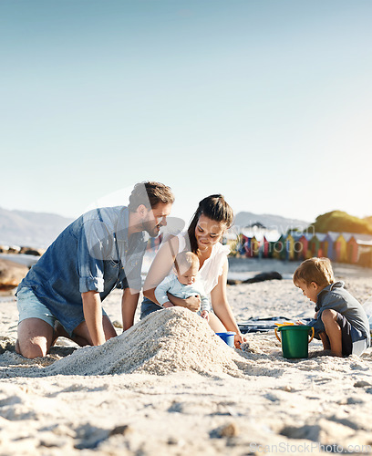 Image of Sandcastle, holiday and children at the beach with family, love and support. Baby, mom and dad together with kids playing in the sun with happiness and smile by the ocean and mockup with bonding