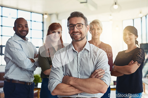 Image of Happy businessman, portrait and arms crossed in leadership, management or CEO team at the office. Confident business people or professional standing with smile for teamwork or about us at workplace