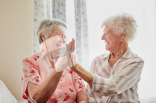 Image of Happy, success and senior women with high five for care, retirement support and happiness. Smile, love and elderly friends with excited gesture for solidarity or community in a nursing home together