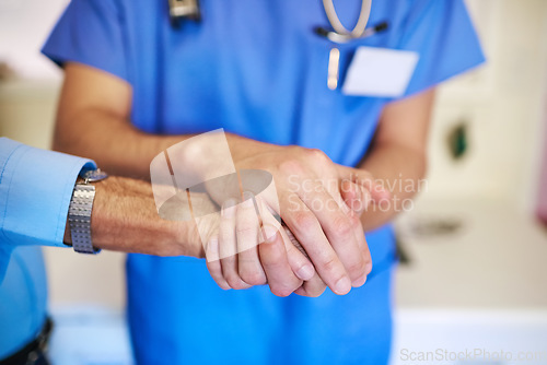 Image of Care, service and a doctor holding hands with a man for healthcare, help and consulting. Caregiver, cancer and closeup of a nurse with a helping hand for a senior person for medical trust and nursing