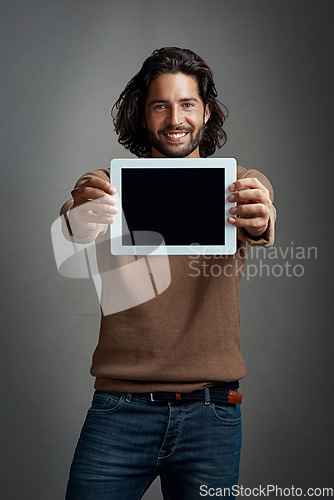 Image of Portrait, tablet screen and happy man with mockup in studio isolated on a gray background. Touchscreen, face and male person with marketing, advertising and technology for commercial promotion space.