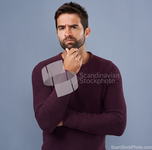 Image of Thinking, confused and portrait of man in studio with unsure, uncertain and thoughtful on gray background. Doubt, mockup space and face of male person skeptical for decision, choice and question