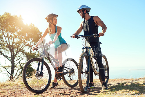 Image of Couple, morning cardio and cycling in the mountains for fitness and exercise together. Bike, wellness and young people with outdoor adventure and sports training with happiness and freedom in sun