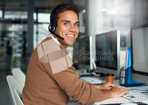 Image of Customer support, telemarketing and portrait of a man in the office doing online consultation on computer. Technology, contact us and male call center consultant working on crm on a pc in workplace.