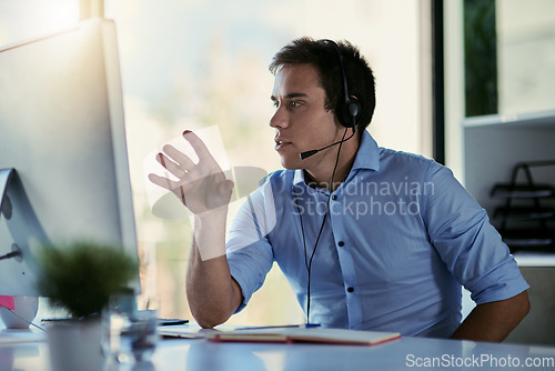 Image of Help desk agent, office and talking, man consulting with advice, sales information and callcenter career. Phone call, conversation and customer support consultant working and speaking at crm agency.