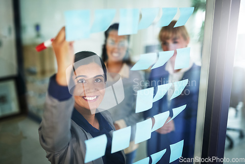 Image of Business people, teamwork or happy woman writing on board for brainstorming a solution, ideas or goals. Planning, sticky note or creative group with leadership for project collaboration together