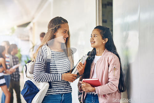 Image of Girl friends, student talk and school with learning books, study and smile on campus. Teenager, teen and girls with happiness and discussion together with textbook ready to start class and learn