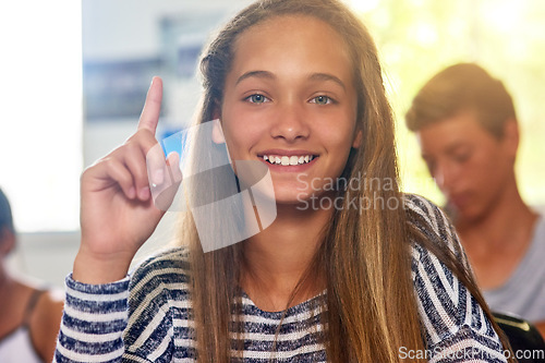 Image of Questions, hands up and portrait of girl in classroom for answer in lesson, school and education. Classroom, knowledge and young female student with hand raised for asking, feedback and learning