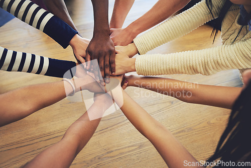 Image of Circle, group and hands stack with people, teamwork and support for motivation, trust or solidarity by desk. Team, helping hand and together with goal, community and friends with top view by table