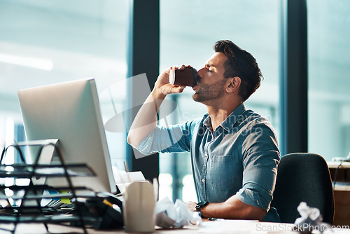 Image of Business man drinking coffee in office at computer in startup agency for productivity, energy and break. Male employee, desktop pc and cup of caffeine at table while working online with technology