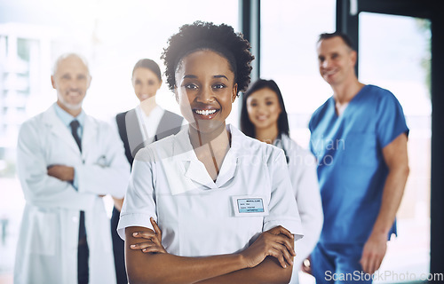Image of Leadership, teamwork and portrait black woman with doctors, nurses and smile in hospital. Healthcare, diversity and medicine, doctor with arms crossed and team of medical employees together in clinic