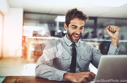 Image of Business man, fist and celebration with laptop, winning or promotion at startup with excited face. Young businessman, winner and celebrate with computer, bonus or profit on investment on stock market