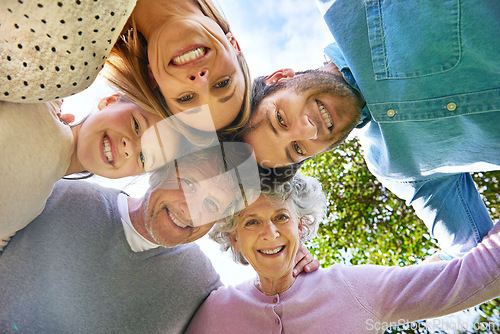 Image of Face portrait, smile and circle of happy family hug, grandparents and parents bond with kid in nature park. Solidarity care, blue sky or bottom view of people smile in garden, forest or outdoor woods