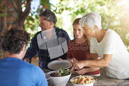 Image of Food, party and salad with family at lunch and serving for health, bonding and celebration. Vacation, social and event with parents and children eating together for dining, generations and wellness