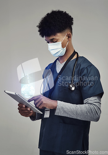 Image of Man, doctor and digital tablet for global communication or healthcare research with covid mask. Male medical expert on technology for data, networking or hologram against a grey studio background