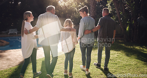 Image of Back, hug and a family in a backyard for sunshine, summer and conversation. Happy, love and parents, grandparents and a child in a home garden with affection, walking and speaking during a visit