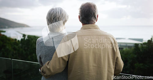 Image of Love, back and senior couple on a balcony enjoying the outdoor view while on a holiday or vacation. Travel, cloudy weather and elderly man and woman on a retirement weekend trip by a resort house.