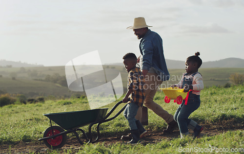 Image of Man, son and daughter working on a farm with a wheel barrow for agriculture in the countryside. Family, farming and children work in the outdoor of a rural environment with joy and fun for learning.