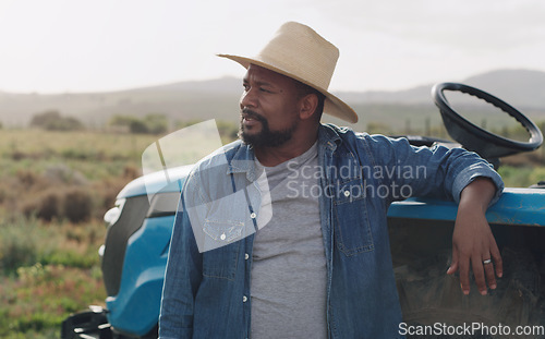 Image of Farming, thinking and a black man with a tractor on a farm for agriculture growth and sustainability. Idea, planning and an African farmer in the countryside with ideas for sustainable business