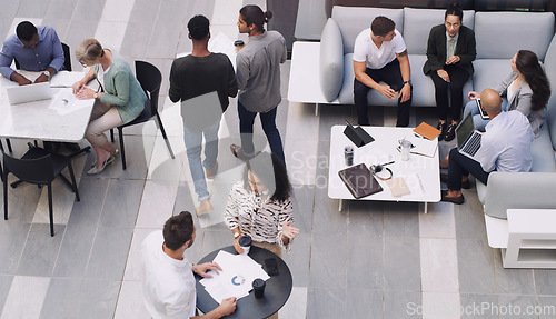 Image of Top view, group and business people in a meeting, conversation and modern office with development. Staff, coworkers and team at a conference, share ideas and relax on a break, talking and teamwork