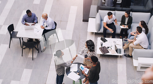 Image of Top view, businesspeople talking and meeting at a conference at their office space. Diversity at work, communication or collaboration and networking or event planning have a conversation together