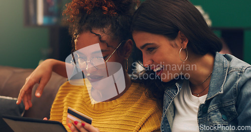 Image of Girl friends, smile and credit card with tablet on a living room sofa with online shopping. Student, happiness and young woman together with web purchase and ecommerce payment app on a home lounge