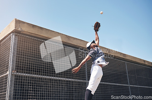 Image of Baseball, catch and man jump for ball in air at pitch for sports competition, action or game. Professional african athlete person playing outdoor for training, exercise and focus on fitness for sport