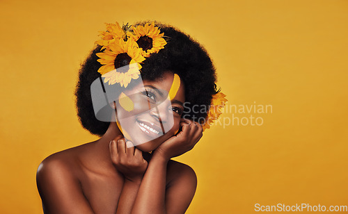 Image of Hair, sunflower and black woman with natural beauty in studio thinking, happy and relax on yellow background. Flower, haircare and African female model smile while contemplating cosmetic or treatment