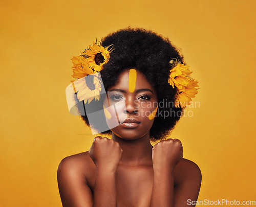 Image of Makeup, sunflower and hair with portrait of black woman in studio for beauty, creative or spring. Natural, cosmetics and floral with face of model on yellow background for art, self love or glow