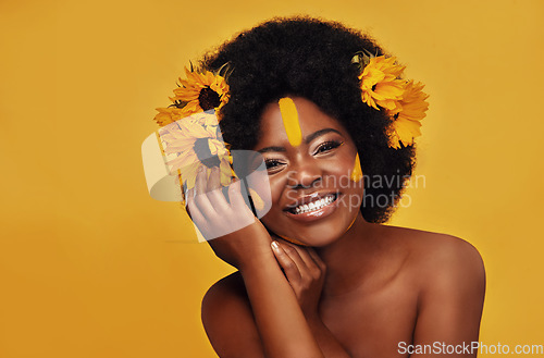 Image of Natural, hair and sunflower with african woman in studio for beauty, creative or spring. Makeup, cosmetics and floral with face portrait of model on yellow background for art, self love or glow