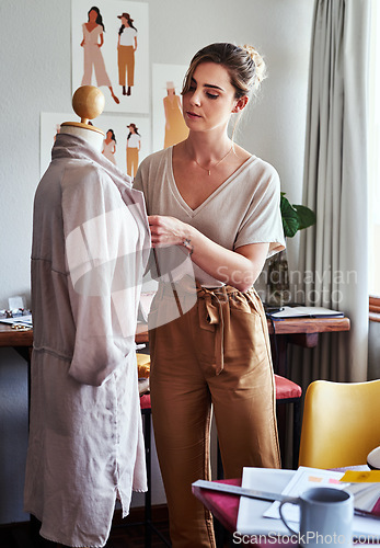 Image of Fashion, woman and designer with mannequin, working and focus at creative small business in clothing boutique. Design, creativity and tailor with dress on doll for clothes in textile start up studio.