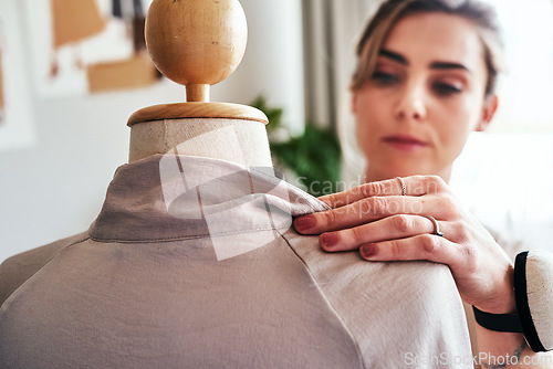 Image of Fashion, hand of woman and tailor with mannequin, focus and creative small business boutique. Closeup, creativity and designer sewing dress on doll for clothes, working in studio or textile start up.