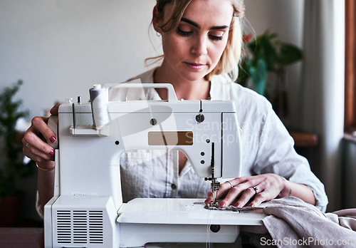 Image of Fashion, woman and textile designer at sewing machine, sustainable business with creative ideas and focus. Creativity, start up and design, or tailor at table stitching fabric, entrepreneur at work.