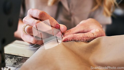 Image of Sewing machine, woman hands and clothing designer with button and thread work. Small business, entrepreneur and female tailor with boutique and creative worker working with machinery for fashion